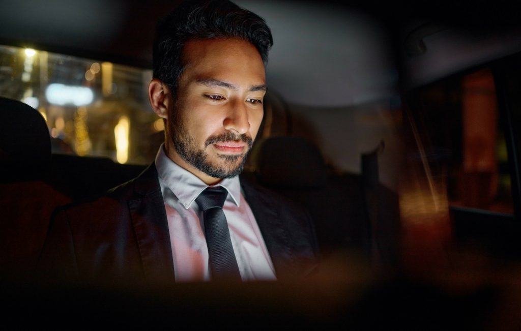 Tablet, travel and business man in car on social media, internet browsing or working. Transport, ni